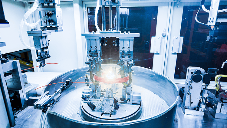 Automated production equipment with a coiled cable assembly