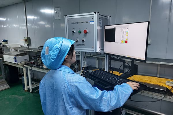 Operator reviewing fiber-optic product inspection results