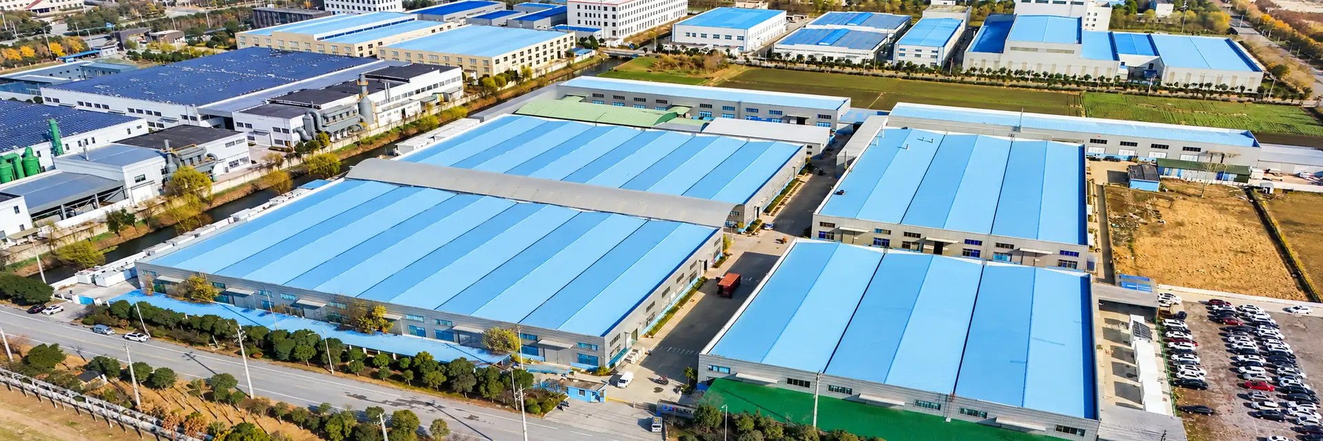 Aerial view of the Huijue Group manufacturing campus with blue-roof factory buildings