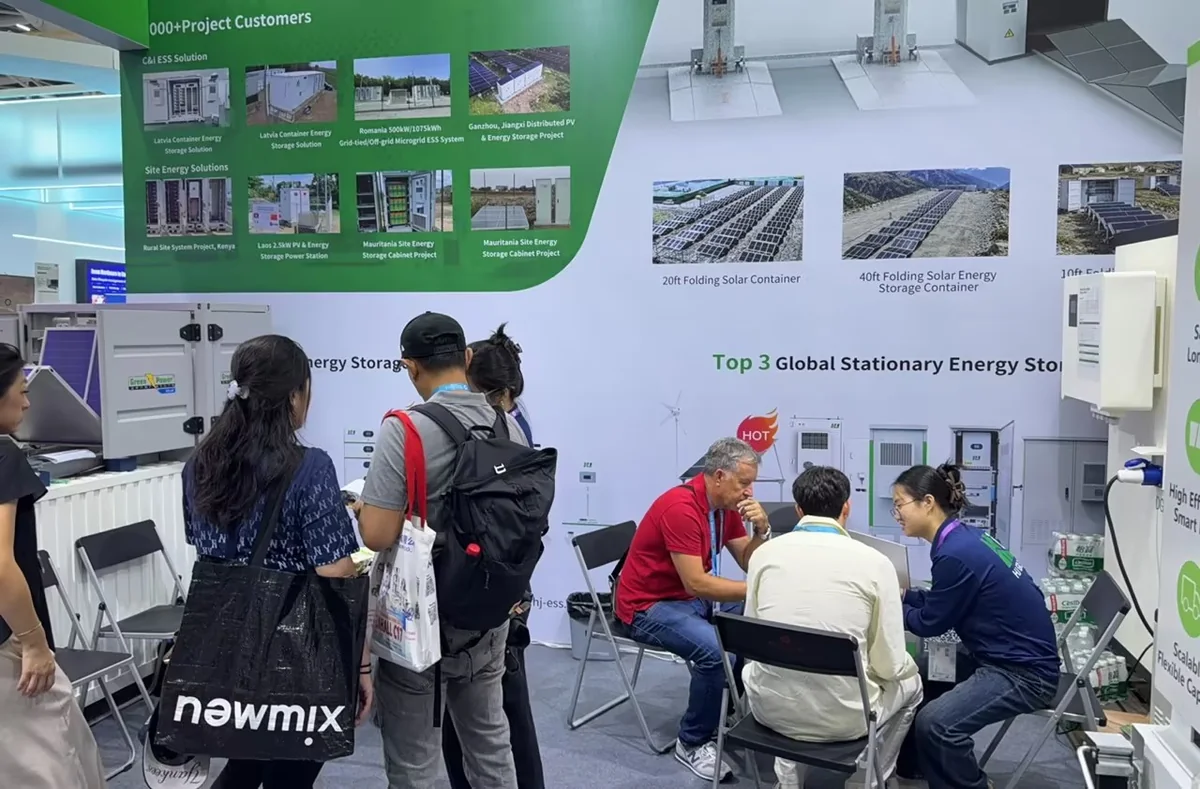 Visitors and the Huijue Group team discussing project requirements at the exhibition booth