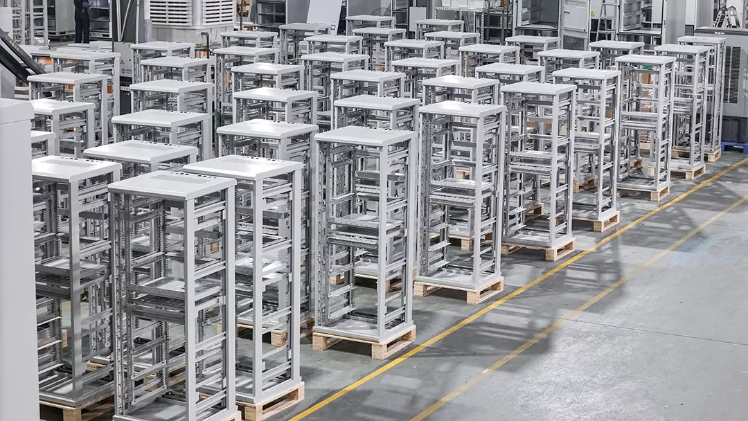 Rows of indoor energy-cabinet frames and assemblies in Huijue Group production